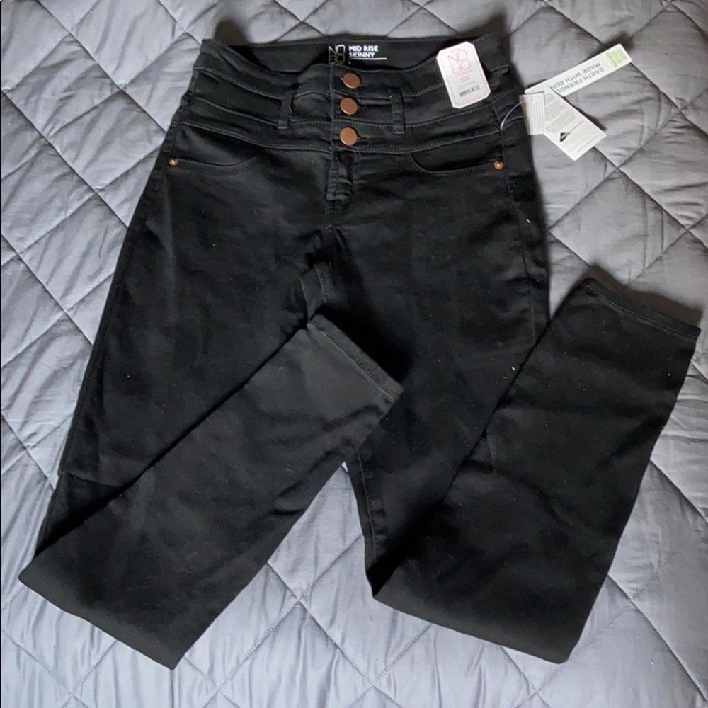 Mid rise button fly black skinny jeans